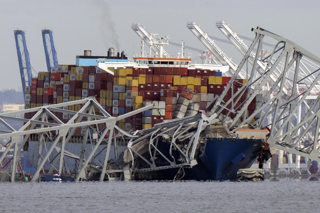 Cargo ship Dali stuck under Baltimore bridge debris.