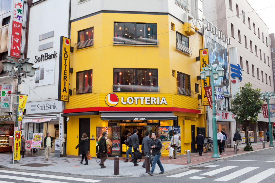 Pedestrians walking​ near Lotteria restaurant